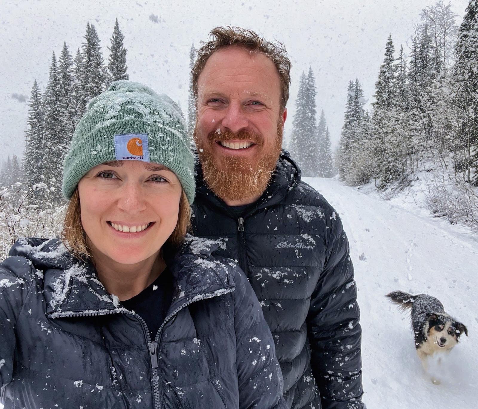 Corey and Jade Buck on a snowy trail with their dog