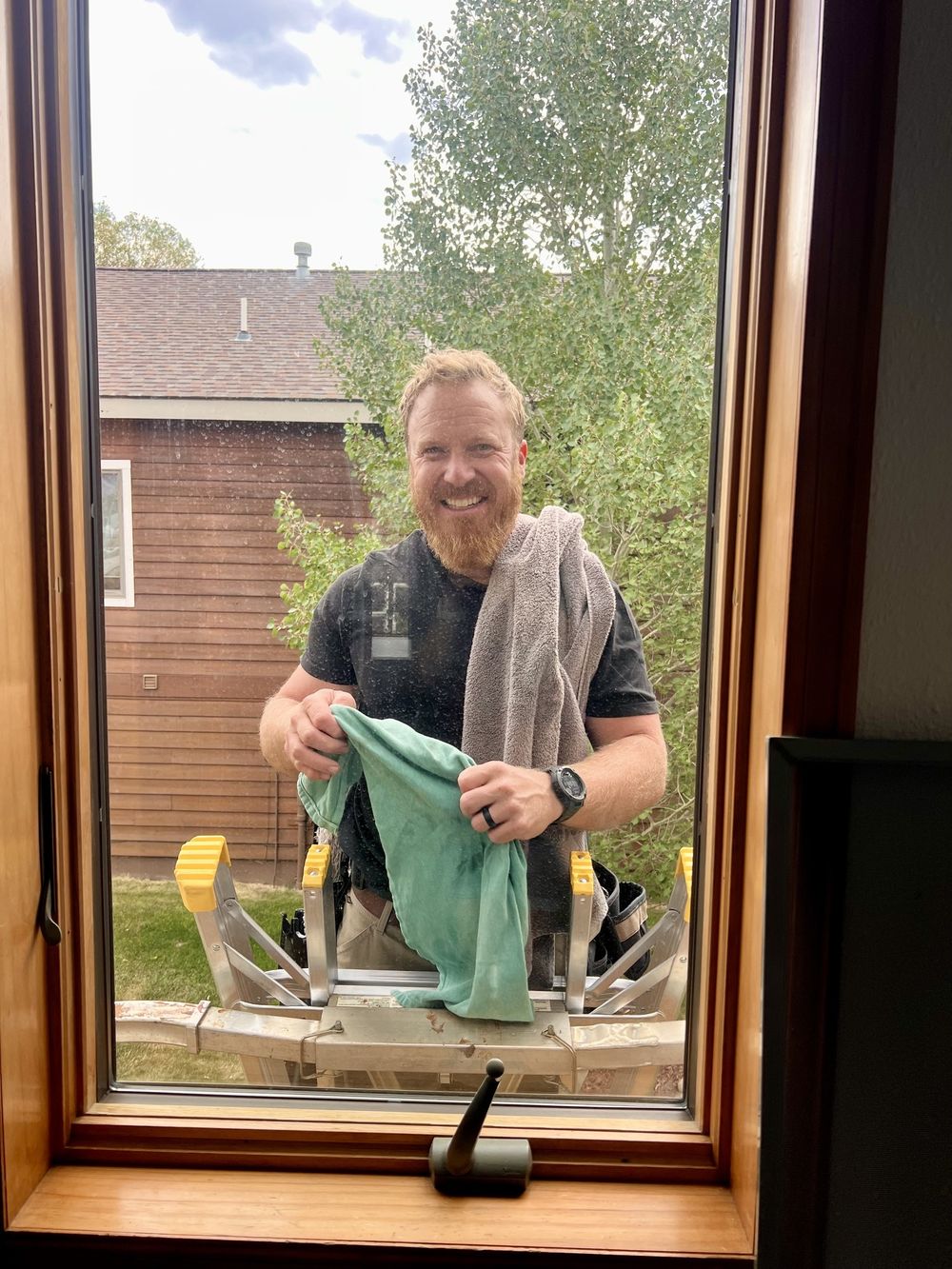 Corey smiling after washing a window